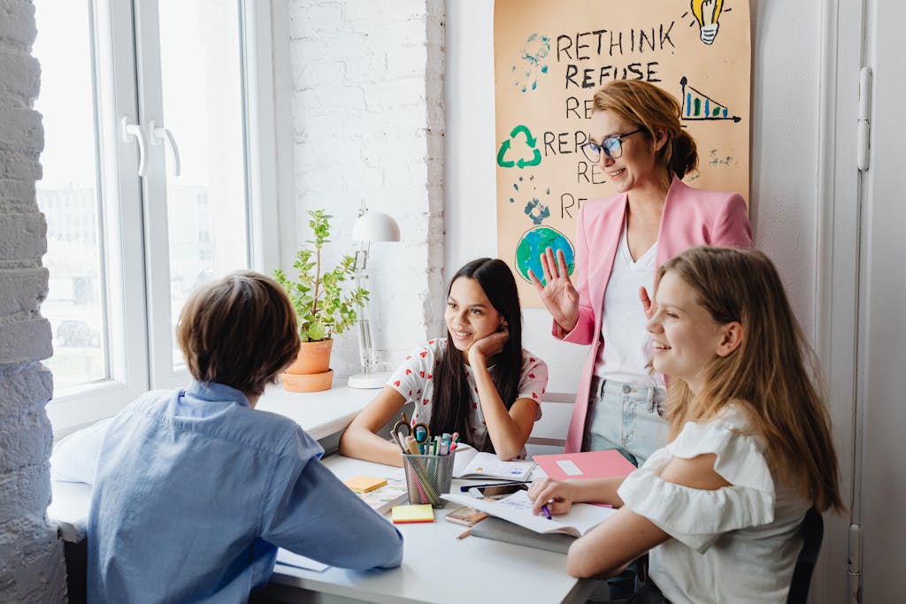 A teacher engages with students in a bright classroom setting, fostering creativity and discussion.
